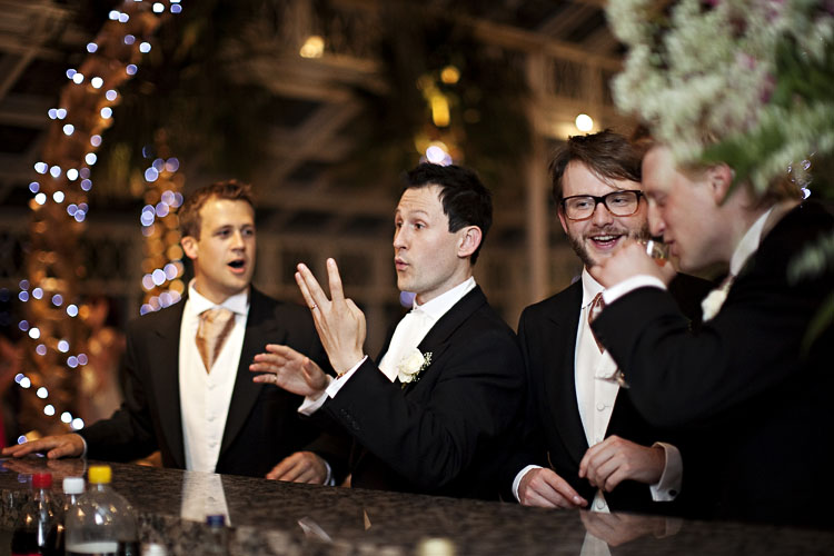 Kit ordering drinks at his wedding by Brighton Wedding Photographer